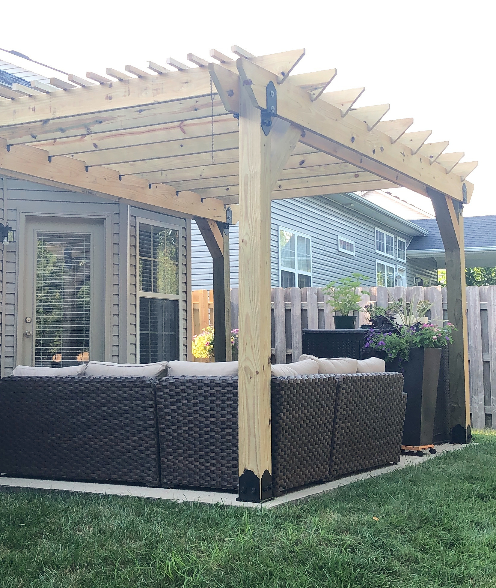 Backyard pergola over a built-in seating area